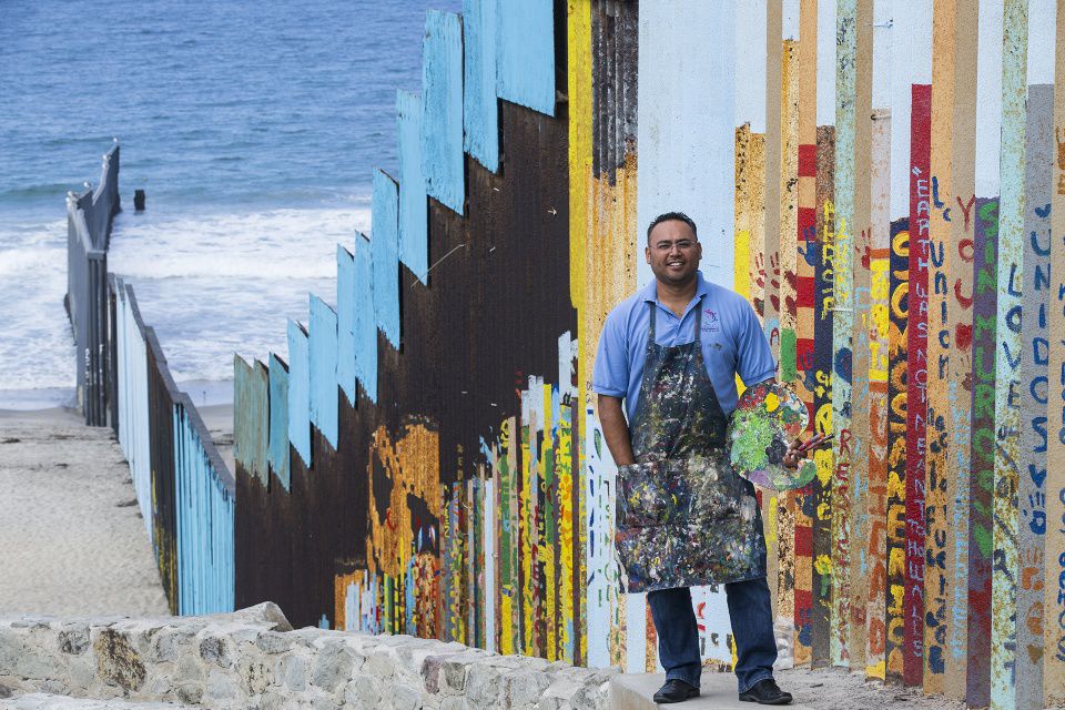 Enrique Chiu at border mural at Las Playas de Tijuana